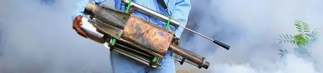 Fumigation technician using a fogger for deep pest treatment in Santa Ana, CA