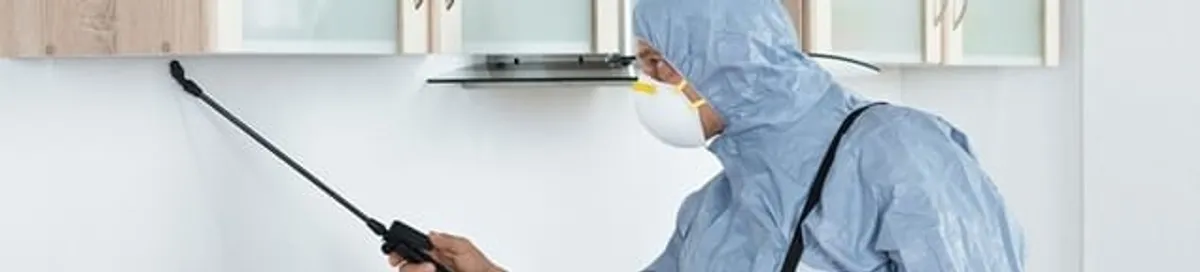 Termite treatment technician applying indoor pest control spray in Santa Ana, CA