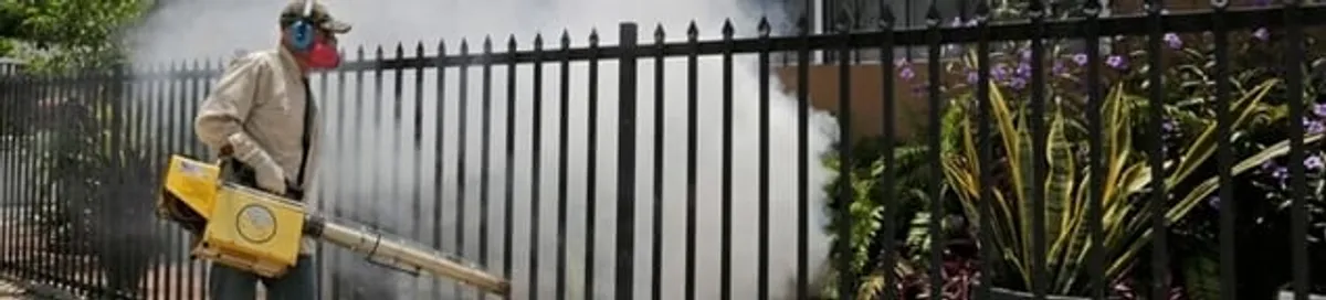 Mosquito control technician fogging a yard perimeter for mosquito reduction in Santa Ana, CA